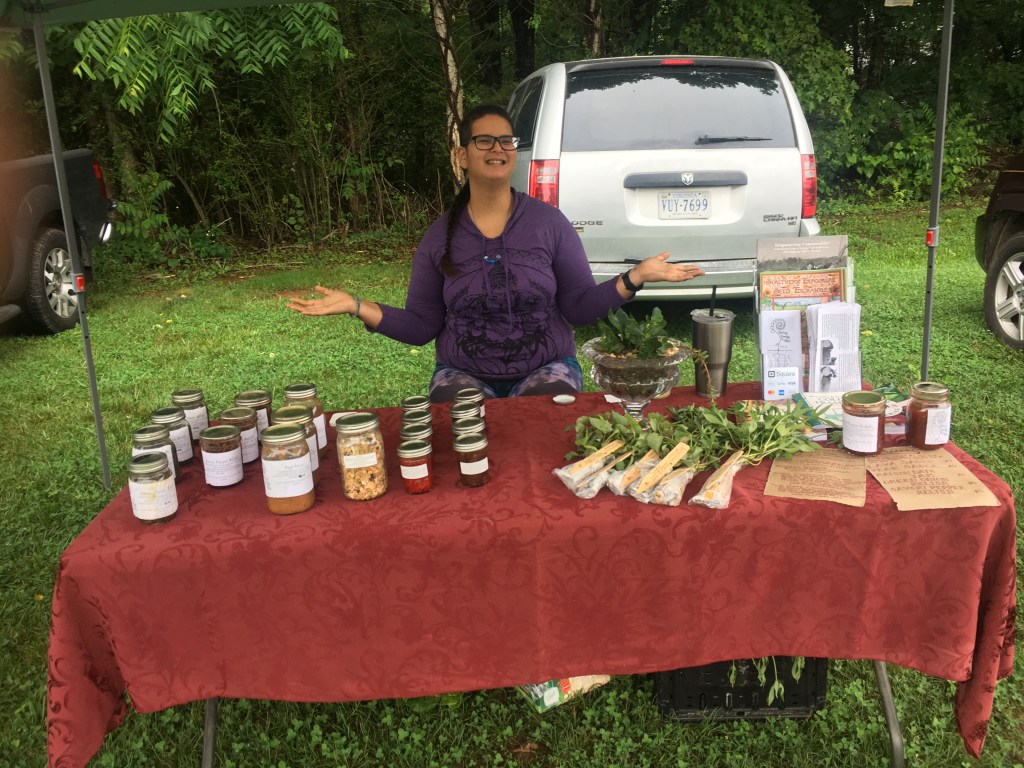 Chenchira selling products from the Louisa communities at Farmers' Market